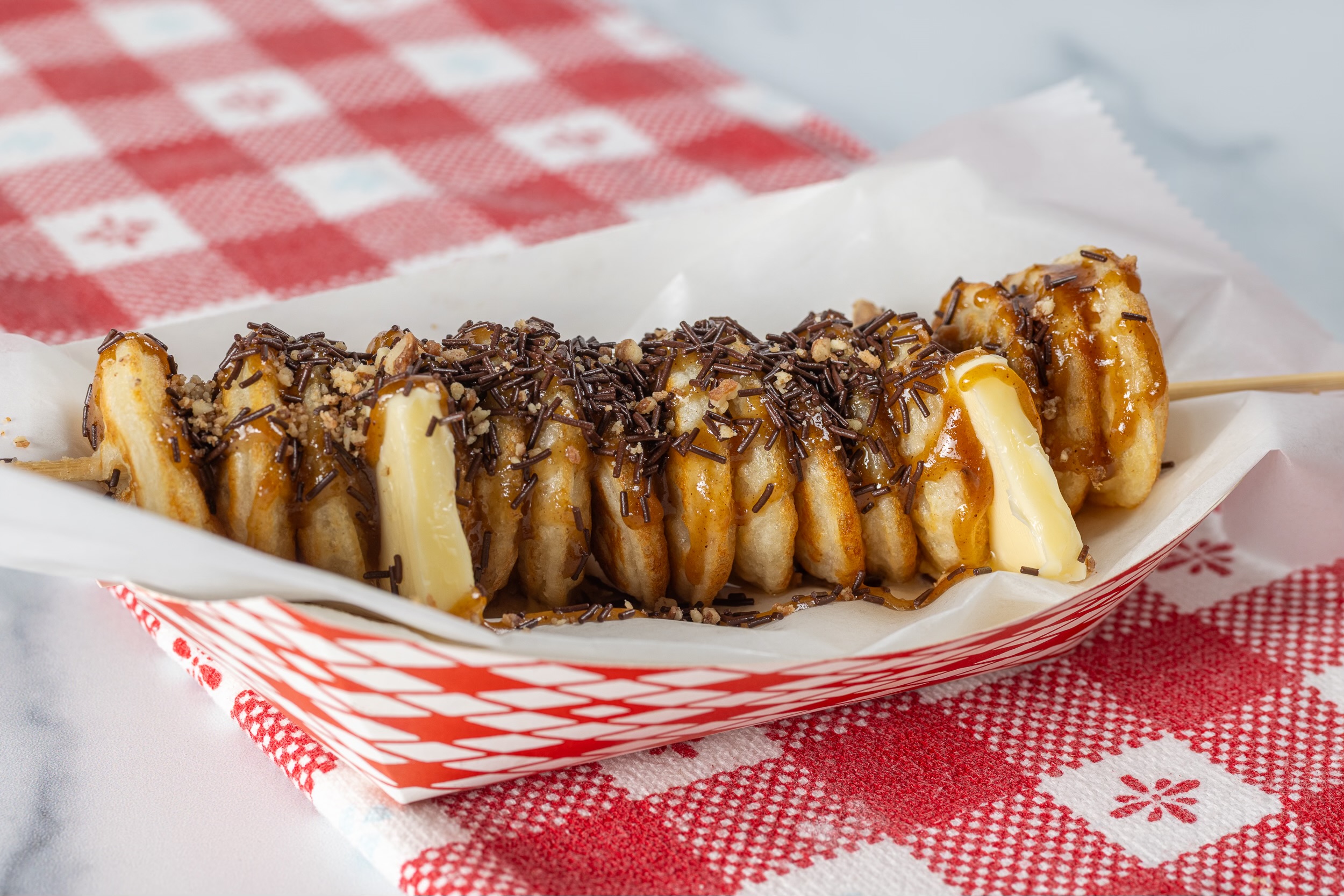 poffertjes with butter, syrup, and chocolate sprinkles